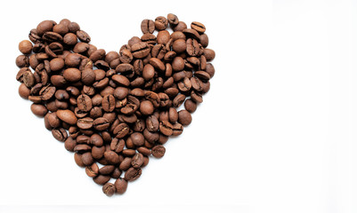 heart shaped roasted coffee beans. coffee day. love for coffee. heart of coffee on a white background. coffee texture with space for text.