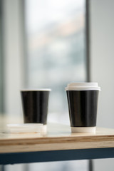 Cup of coffee to go in coffee house cafe daylight sunrise sunset morning city street