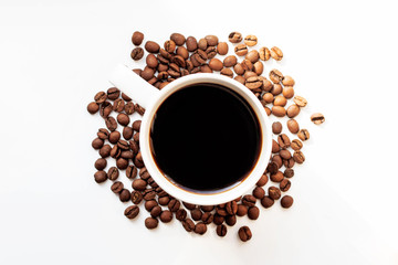 coffee top view. black coffee on a white background around coffee beans. coffee in a white mug. coffee day. morning coffee