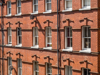 East London, England UK. Traditional red brick housing and flats. Sash windows. Concept, buying, renting, estate agent, urban housing and living in the city, London lockdown, copy space