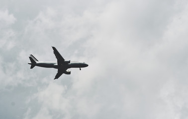 Fototapeta na wymiar jetliner aircraft flying low pass over an airport