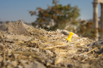 Yellow pin stuck in the ground