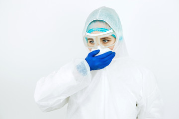 portrait of tired doctor after shift in the hospital. The doctor in protective clothing - glasses,...