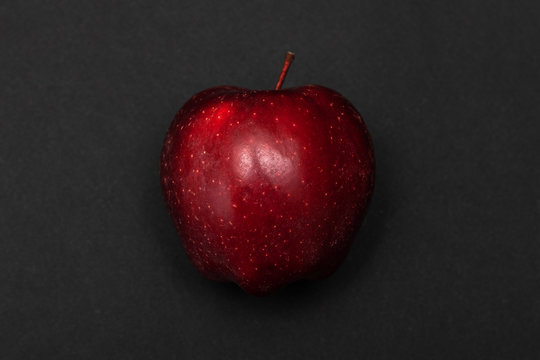 Dark Red Apple On Black Paper Background