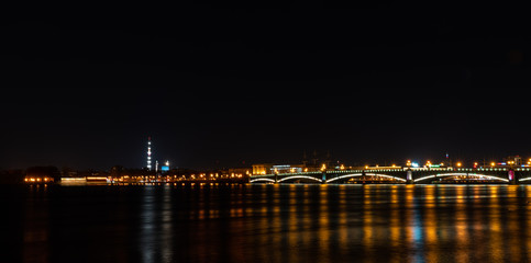 Fototapeta na wymiar Night city lights over the river