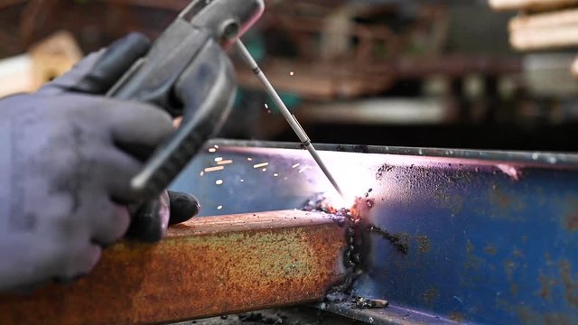 Close-up of the welding process of two metal parts in slow motion .