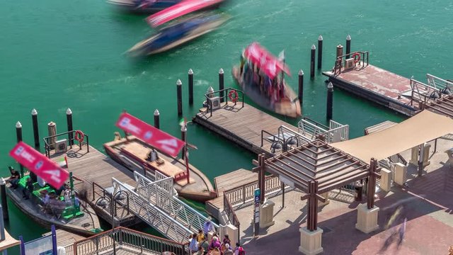 A water taxi boat station in Deira timelapse. Cloudy sky and abra boats, passengers can board a Dubai Water Taxi to travel around the emirate on certain set routes.