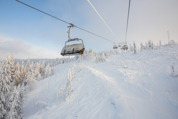 Fototapeta na wymiar Ski lift in the snow mountains