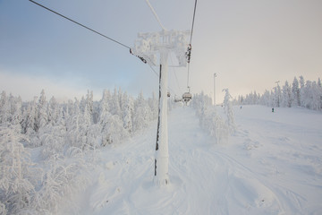Fototapeta na wymiar Ski lift in the snow mountains