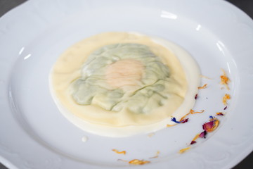 Delicious raviolo pasta on a creamy sauce. Italian Cuisine