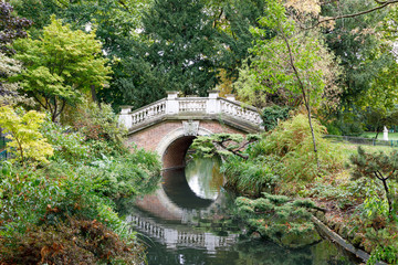 Ornate bridge over water in Parc Monceau in Paris, France