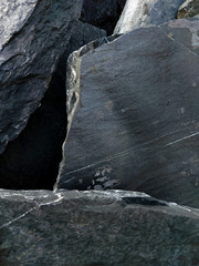 Dark Aged Shabby Cliff Face And Divided By Huge Cracks And Layers. Coarse, Rough Gray Stone Or Rock Texture Of Mountains, Background And Copy Space For Text Rock Shelf for a Product Display