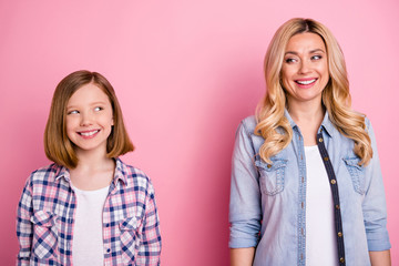 Portrait of candid charming mother and her daughter woman kid look each other enjoy wear denim jeans checkered plaid shirt isolated over pastel color background