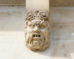 Face carved into the Pont Saint Michel bridge in Paris, France