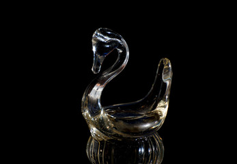 Glass figure of a swan on a black backgroundlass figure of a swan on a black background