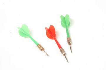 two green darts and one red on a white background isolate