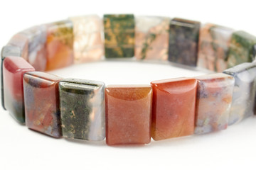 bracelet made of agate beads on a white background. close up