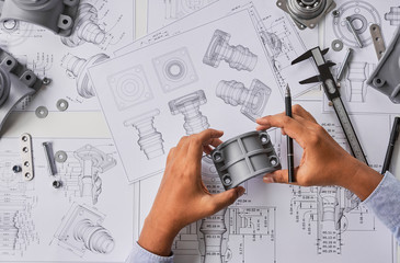 Engineer technician designing drawings mechanical parts engineering Engine.manufacturing factory...
