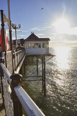 Direct Sun on the pier at the seaside looking out to sea
