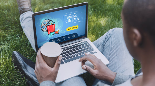 African American Man With Laptop Browsing Online Cinema Website In Park, Collage