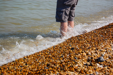 Man paddling in the sea on english coastline