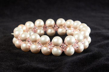 bracelet from pink Mallorca pearls semiprecious stone on black velor. close up
