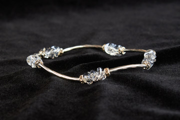 semi-precious stone crystal bracelet on black velor. close up