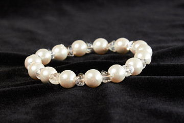 bracelet from pink Mallorca pearls semiprecious stone on black velor. close up