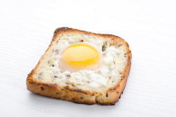 Closeup of tasty and hot egg in the basket on the white background

