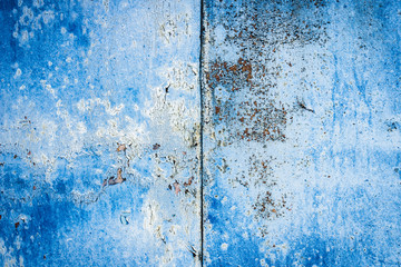 Texture of a rusty metal surface: dark blue, blue, aged cracked paint. Background of old painted sheet metal with rust painted in blue.