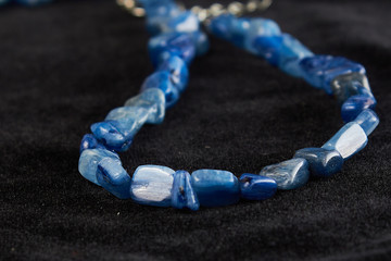 beads made of crumbs lapis lazuli semiprecious stone on black velor. close up
