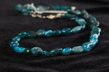 beads made of crumbs lapis lazuli semiprecious stone on black velor. close up