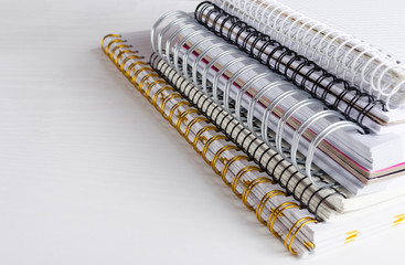 Closeup of spiral notebooks on the white table.Different types of notebooks
