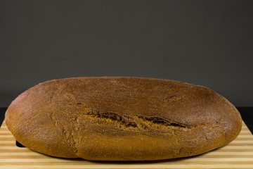 Black bread with sesame seeds. On board