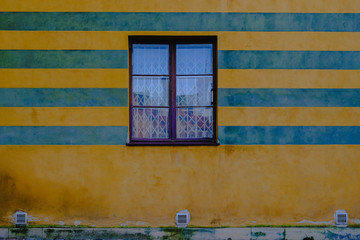 Window on a bright striped wall