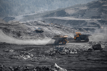 Open pit mine industry, big yellow mining truck for coal and site preparation for blasting