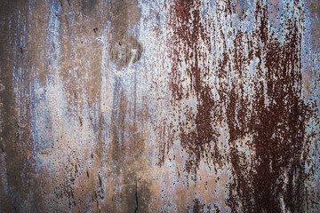 Texture of a rusty metal surface: dark blue, blue, aged cracked paint. Background of old painted sheet metal with rust painted in blue.