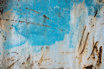 Texture of a rusty metal surface: dark blue, blue, aged cracked paint. Background of old painted sheet metal with rust painted in blue.
