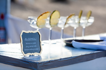 Tropical passion fruit juice alcoholic cocktail standing outdoor in sunlight 