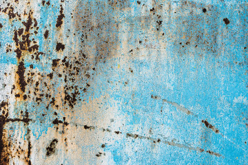 Texture of a rusty metal surface: dark blue, blue, aged cracked paint. Background of old painted sheet metal with rust painted in blue.