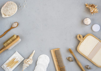 Fototapeta na wymiar Zero waste bathroom accessories, natural sisal brush, wooden comb, sea salt, body cream, bamboo toothbrush, washcloth and cotton buds. Top view, flat lay, copy space