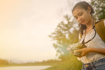 Women carrying cameras and bags ready to travel