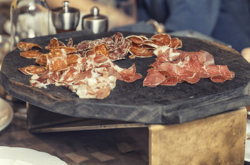 Assorted spicy cold Smoked beer snacks salty dried meat on restaurant dinner table