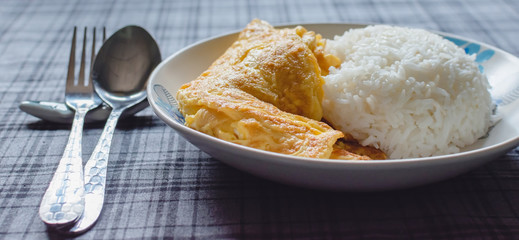 Omelet (Omelette, Scrambled) with nature light on blue wood table, Fresh ingredient and put some soy sauce, sugar and pepper, In Thailand, popular eating with hot jasmine rice, Copy space...
