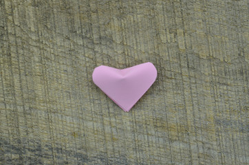 A folded pink paper heart