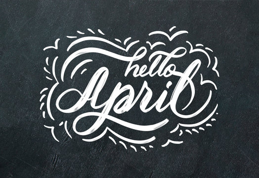 "Hello April" hand lettering inscription and hand drawn flowers on black chalkboard background.