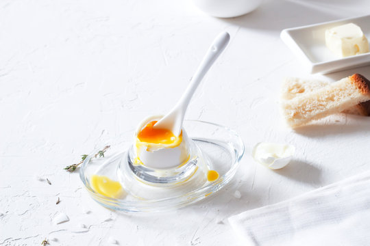 Traditional morning breakfast, boiled eggs, butter, bread, milk, on a white background, modern style

