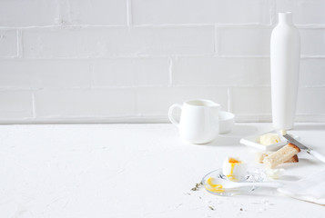 Traditional morning breakfast, boiled eggs, butter, bread, milk, on a white background, modern style

