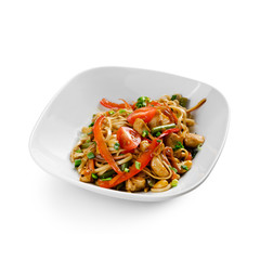 Fried udon noodles in a wok with chicken fillet and green beans. Traditional asian food.
