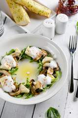 Appetizer with mozzarella cheese, arugula and mushrooms